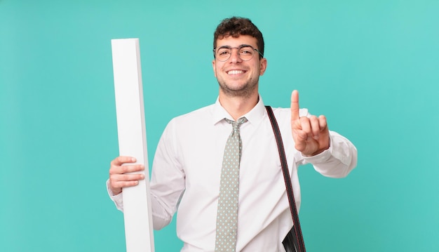 Arquitecto sonriendo con orgullo y confianza haciendo la pose número uno triunfalmente, sintiéndose como un líder