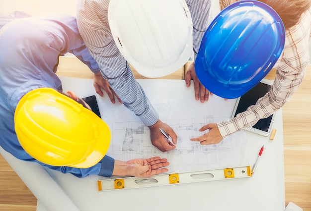 Foto arquitectos e ingenieros convocan y planifican acciones conjuntas con compromiso. vista desde arriba de la imagen.