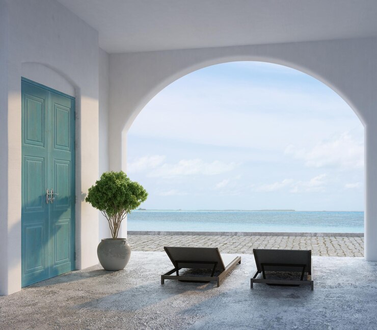 Arquitectura de estilo santorini con vista al mar y tumbona.