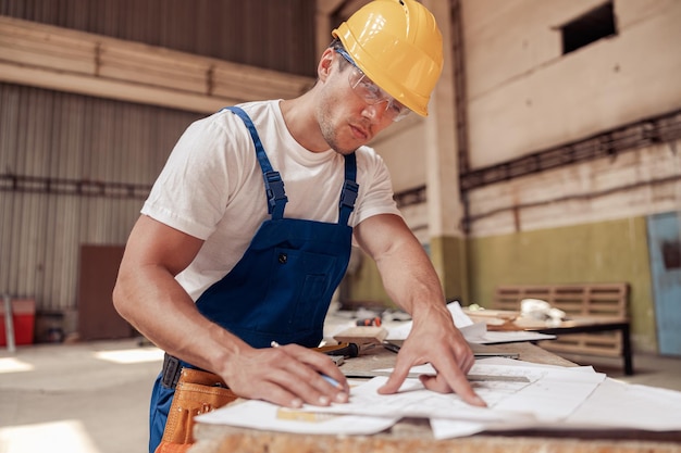 Arquiteto bonito desenhando plano arquitetônico de construção