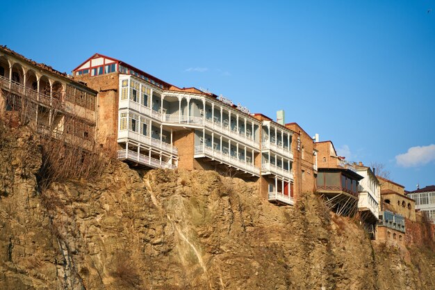 Arquitetura antiga de Tbilisi. Desenvolvimento denso de um edifício residencial em uma falésia à beira do rio.