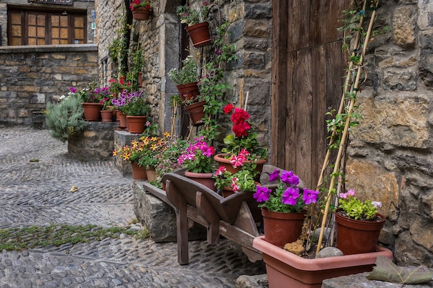 Arquitetura de casa de pedra medieval com flores na vila de ainsa, espanha