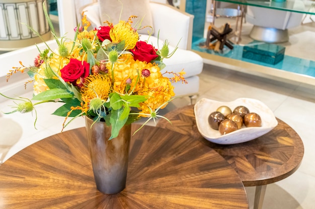 Arranjo floral de rosas e cravos que decoram a sala de estar da casa