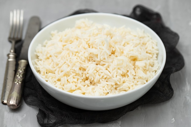 Arroz cozido em uma tigela em fundo cinza