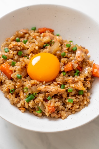 arroz frito de salmón con huevo encurtido encima. Estilo de comida asiática