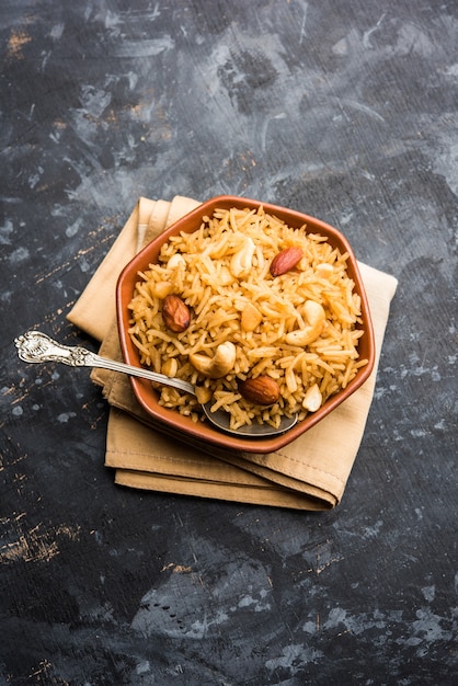 Arroz jaggery tradicional ou gur wale chawal em hindi, servido em uma tigela com colher. foco seletivo