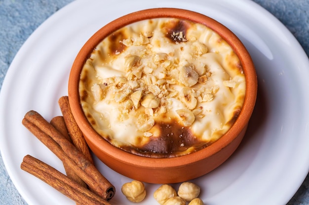 Arroz con leche al horno postre lechoso turco sutlac en cazuela de barro con avellanas