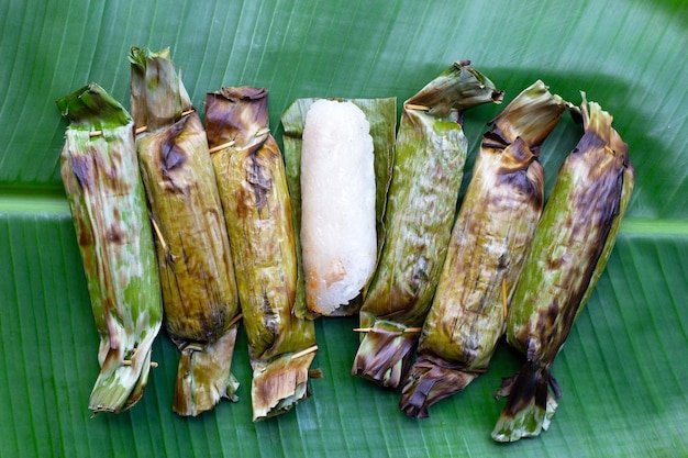 Arroz pegajoso grelhado em folhas de bananeira com recheio de banana