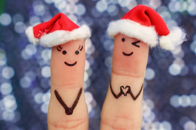 El arte de los dedos de la pareja celebra la Navidad