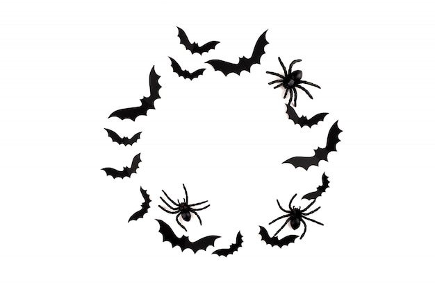 Arte em papel de halloween. morcegos de papel preto voando e aranhas em branco.