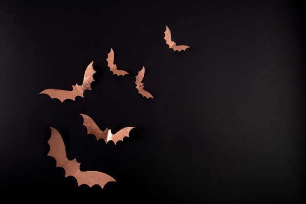 Foto arte em papel de halloween. morcegos de papel preto voando no preto