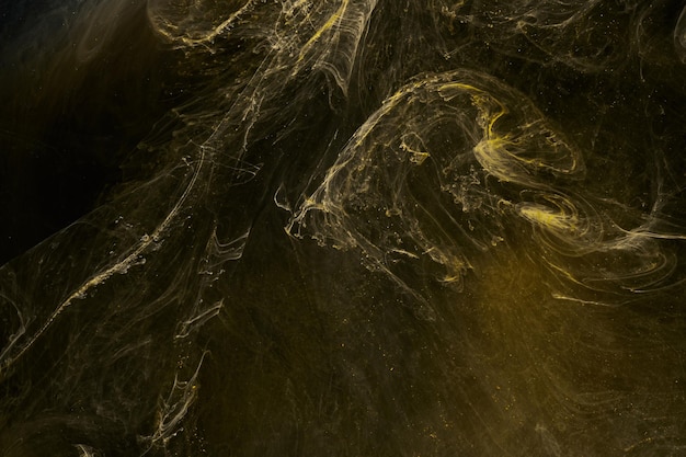 Arte fluida líquida fundo abstrato preto amarelo dançando tintas acrílicas espaço subaquático fumaça oceano