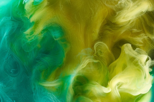 Arte fluida líquida Fundo abstrato Verde amarelo dançando tintas acrílicas debaixo d'água espaço fumaça oceano cor explosão