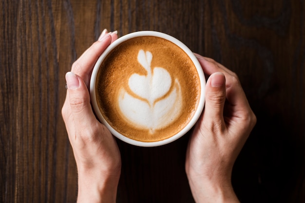 Arte latte quente na mesa de madeira