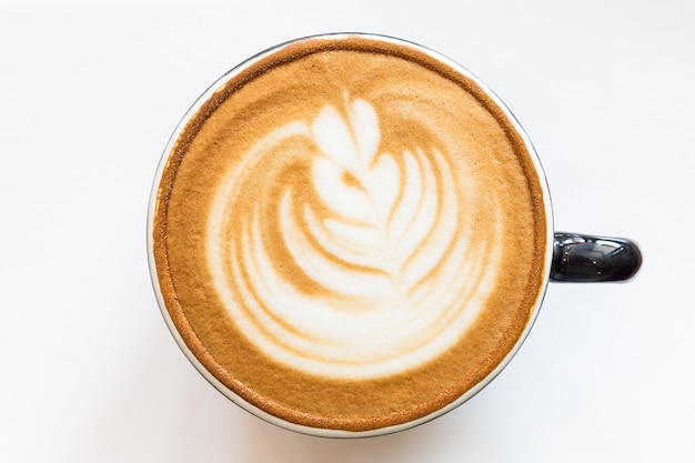 Arte del latte de la taza de café en la mesa