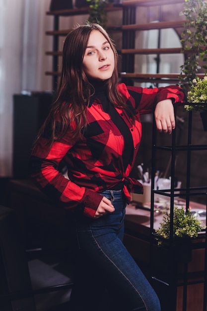 Arte retrato de una hermosa niña. hermosa chica morena, retrato en luces de la ciudad de noche. Retrato de moda de moda de mujer joven y bella mujer con cabello largo y rizado oscuro.