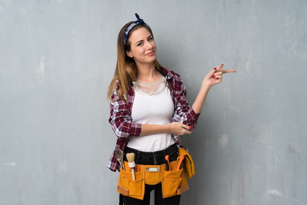 Artesãos ou eletricista mulher apontando o dedo para o lado