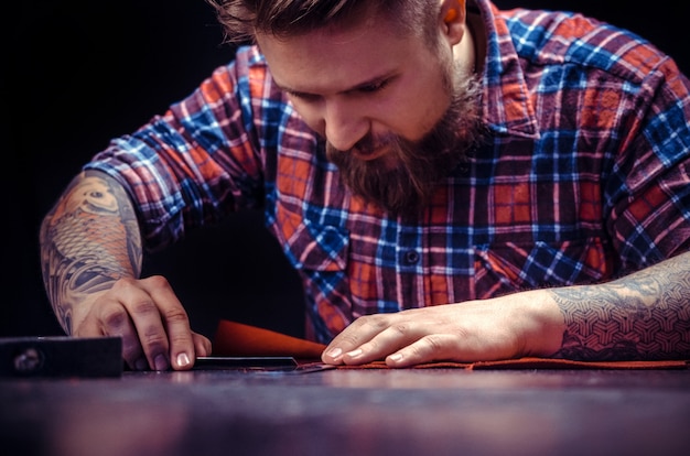 Artista de cuero formando una nueva producción de cuero en el estudio de cuero