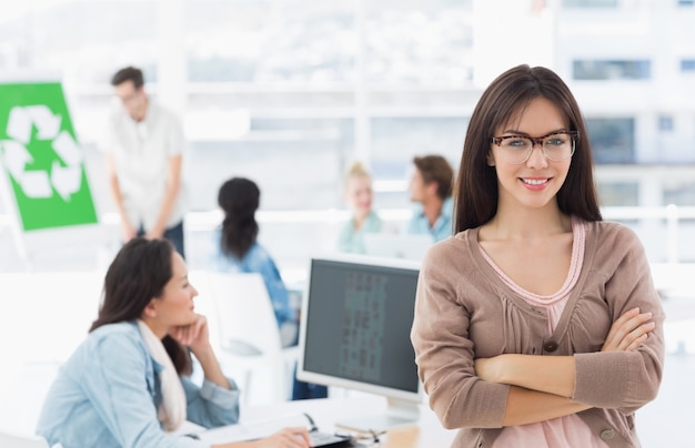 Artista femenina con colegas en el fondo en la oficina