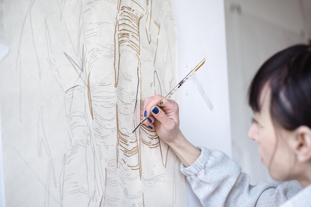 Artista femenina dibujando pintura con pincel y pintura negra Pintura gráfica Creación de arte moderno