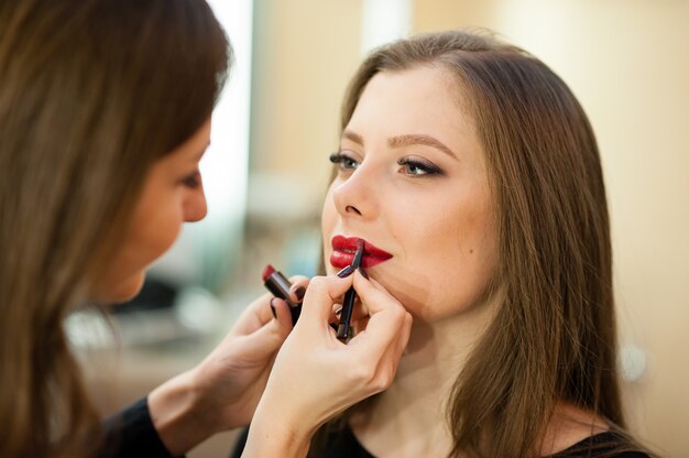 Artista de maquillaje hace cambio de imagen hermosa chica