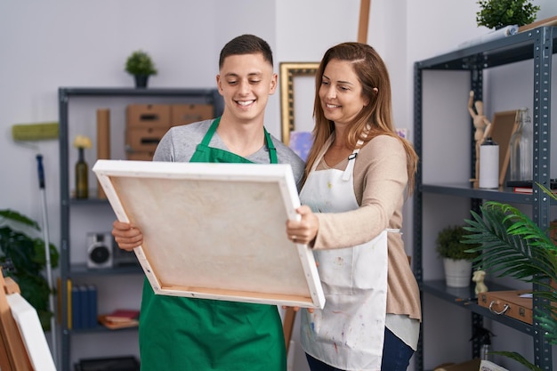 Artistas de homem e mulher segurando desenho no estúdio de arte