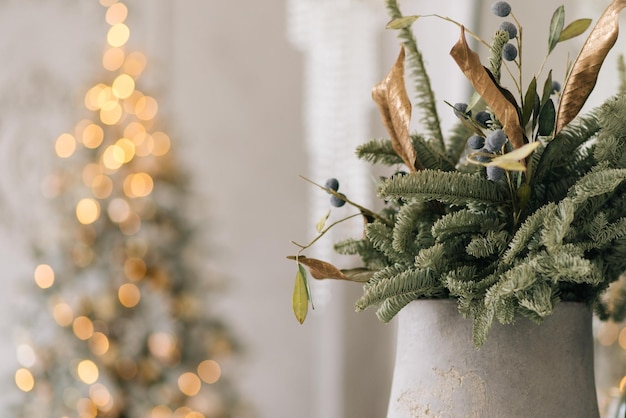 Árvore de abeto de decoração de natal na frente e luzes da guirlanda