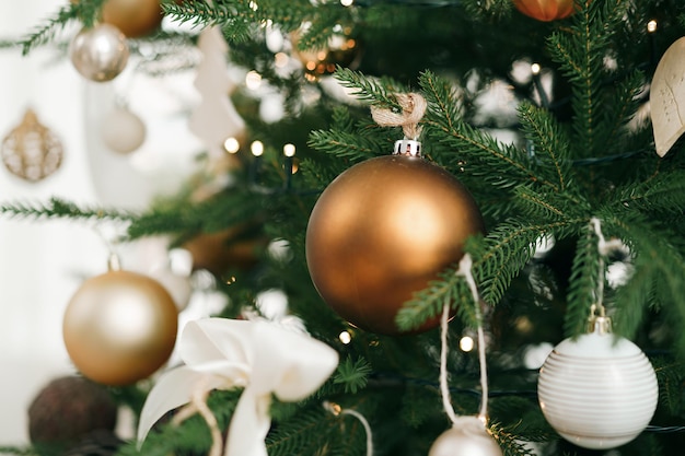 Árvore de natal decorada com bolas brancas e douradas close up foto