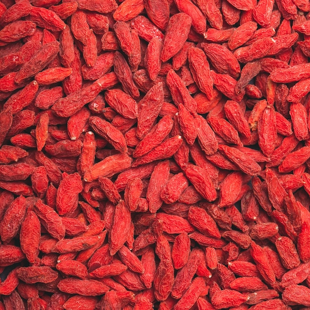 As bagas vermelhas secas de goji como pano de fundo