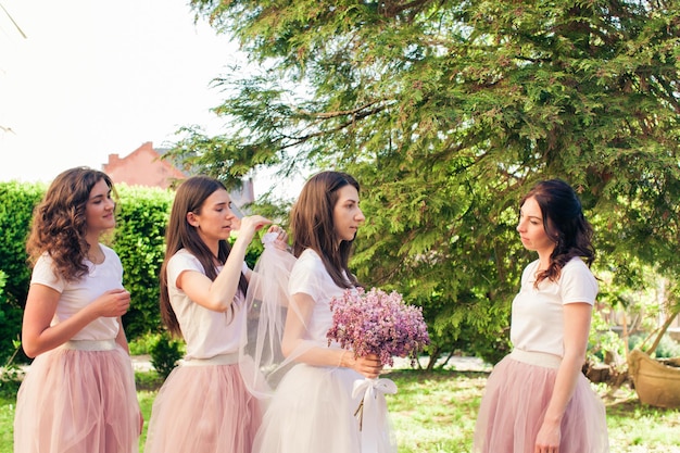 As damas de honra estão preparando a noiva para o casamento