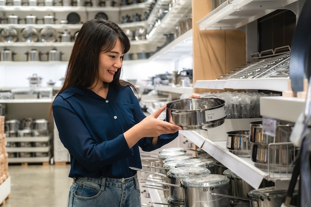 As mulheres asiáticas estão optando por comprar novos utensílios de cozinha no shopping. compras de mantimentos e utilidades domésticas.
