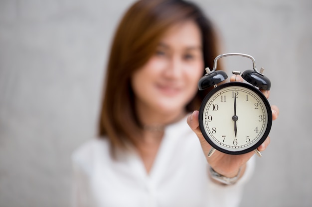 Foto as mulheres asiáticas mostram tempos de relógio às 6 horas, é hora de fazer algo conceito