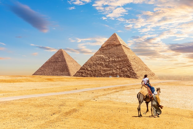 As pirâmides do egito khafre e quéops e beduínos com turistas no deserto de gizé