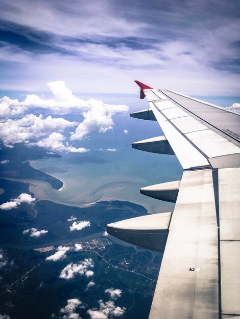 Foto asa de avião contra o céu nublado