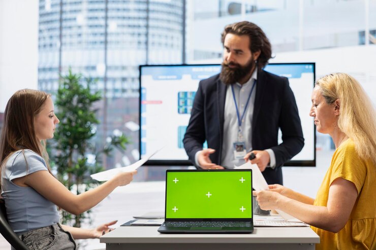 Foto asesor financiero que muestra a los clientes las tendencias del mercado de valores en una computadora portátil de pantalla verde