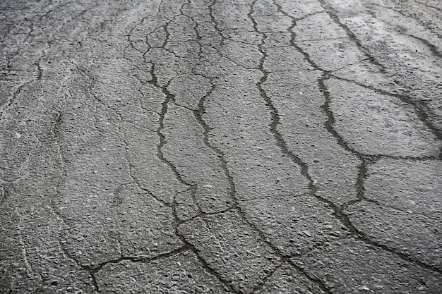 Asfalto en grietas textura / fondo abstracto grietas en la carretera asfaltada