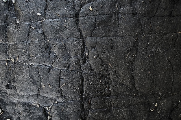 asfalto en textura de grietas / grietas de fondo abstracto en carretera asfaltada