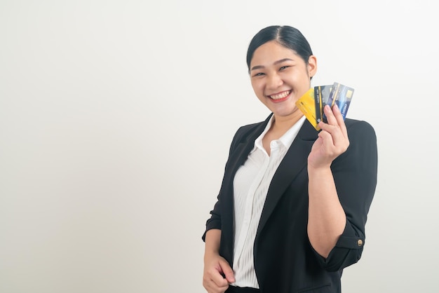 Asiatin, die Kreditkarte mit weißem Hintergrund hält