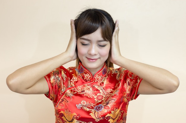 Foto asiatingruß im traditionellen chinesen oder im cheongsam mit händen weg