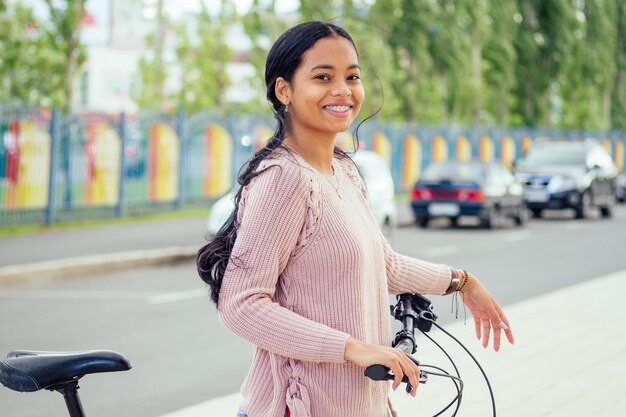 Asiatische Frau, die in der Innenstadt ein Fahrrad zur Miete nimmt