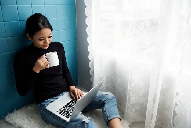 Asiatische Frau mit Computer-Laptop