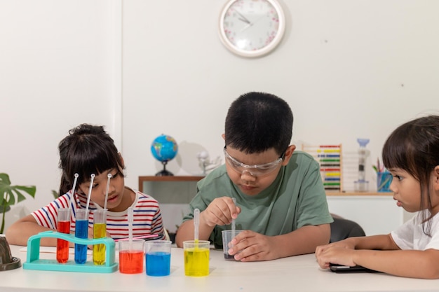 Asiatische Kinder führen in ihrem Haus chemische Experimente durch