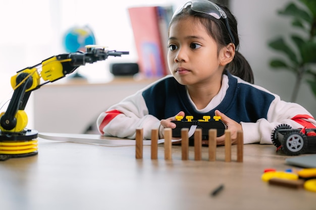 Asiatische Mädchen lernten Roboterprogrammierung und erhielten Lektionen über die Kontrolle von Roboterarmen Labor Mathematik Ingenieurwissenschaft Technologie Computercode Codierung STEM-Ausbildung