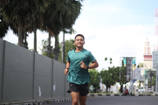 Asiatischer Junge, der sich vor dem Joggen aufwärmt