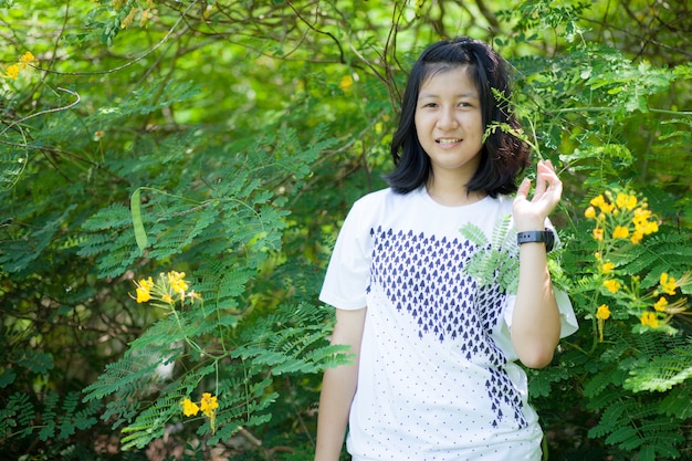 asiatisches Mädchen und gelbe Blume.