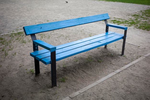 Asiento exterior de madera azul con diseño paisajístico