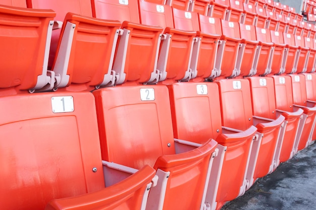 Asientos naranjas vacíos en el estadioFilas de asiento en un estadio de fútbol