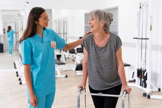 Foto assistente médico ajudando paciente com exercícios de fisioterapia