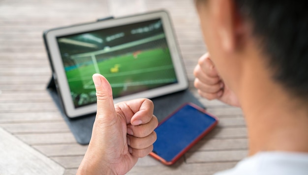 Assistindo jogo de esportes de futebol em tablet digital