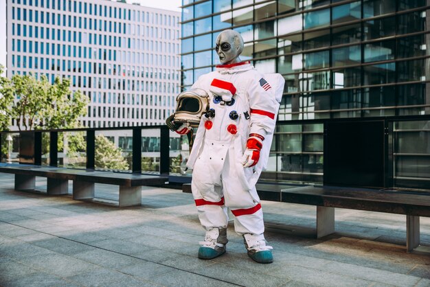 Astronauta alienígena en una estación futurista. astronauta con traje espacial caminando en un área urbana